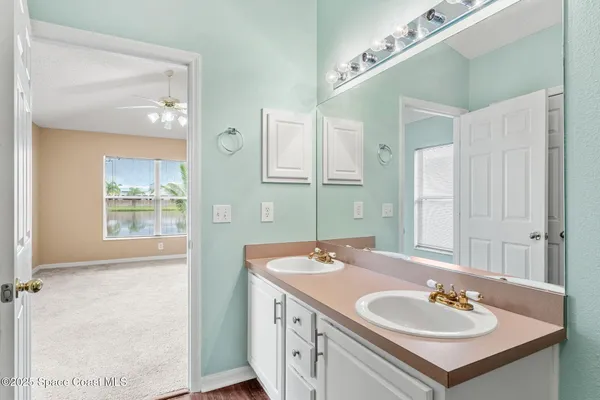 a bathroom with a sink double vanity and a mirror