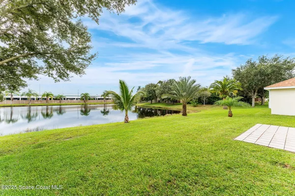 a view of a swimming pool with a yard and lake view