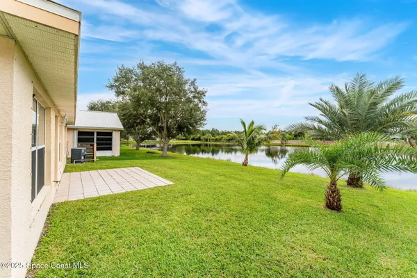 a view of yard with swimming pool and green space