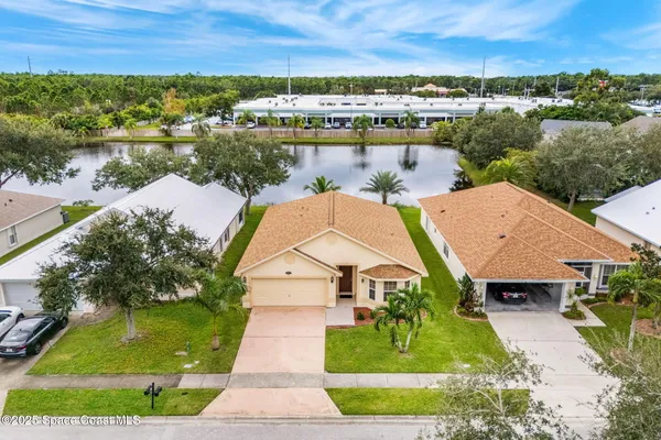 an aerial view of a house with a yard