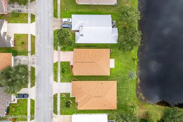 an aerial view of residential houses with outdoor space and street view