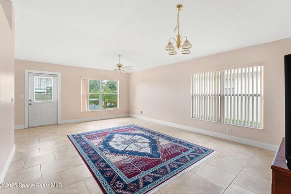 an entryway with a window and a rug