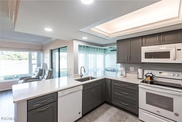 a kitchen with a sink stove and microwave