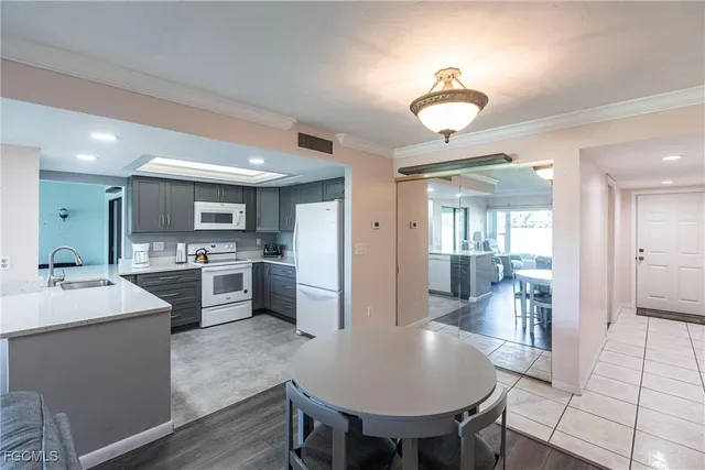 a large kitchen with a table and chairs