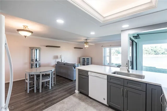 a kitchen with a table chairs and white cabinets