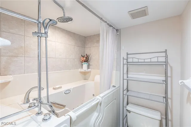 a bathroom with a tub and shower