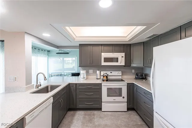 a kitchen with a sink a stove and refrigerator