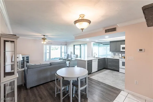 a kitchen with refrigerator cabinets dining table and chairs