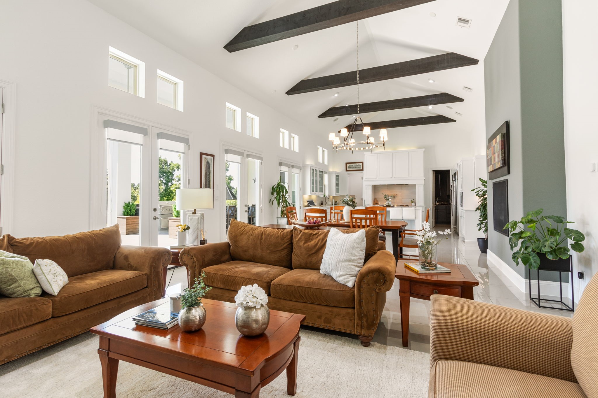 28518 Hoffman Spring Lane Fulshear, TX 77441 - Photo 50 of 50 Walk into this Grand Open Concept Floorplan and Immediately it takes your Breath Away! Framed by soaring cathedral ceilings with rich wood beams and a full wall of windows that floods this area with natural light.