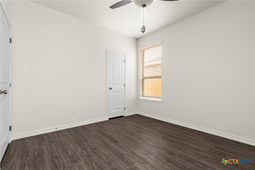 5221 Rose Gdn Loop Killeen, TX 76542 - Photo 17 of 29 an empty room with wooden floor and windows