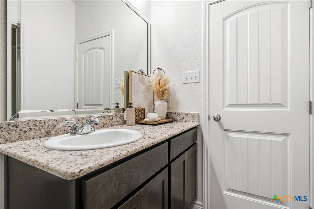 5221 Rose Gdn Loop Killeen, TX 76542 - Photo 18 of 29 a bathroom with a granite countertop sink and a mirror