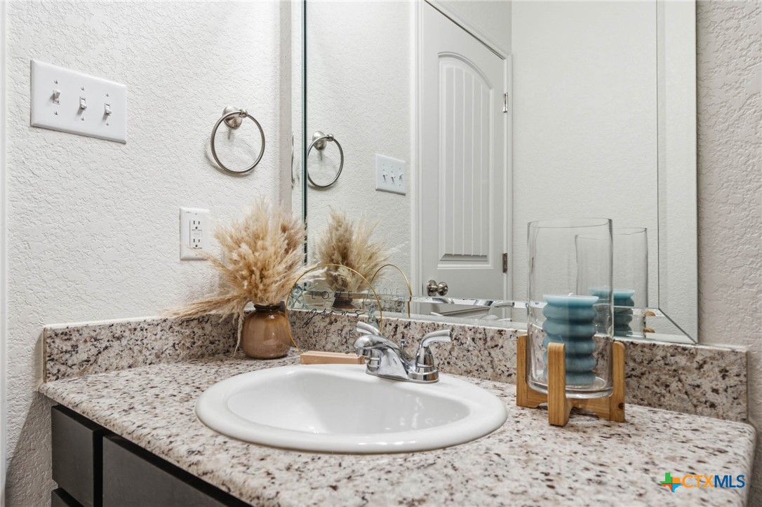 5221 Rose Gdn Loop Killeen, TX 76542 - Photo 22 of 29 a bathroom with a granite countertop sink and a mirror