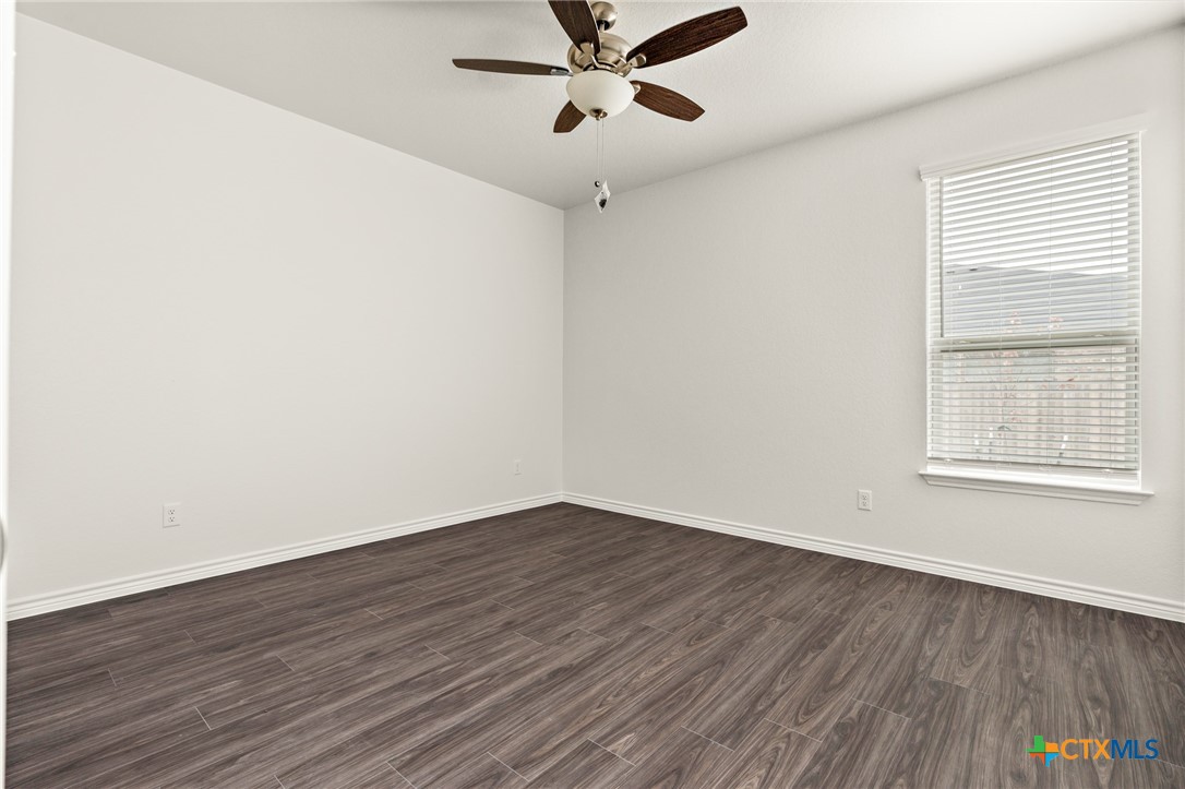 5221 Rose Gdn Loop Killeen, TX 76542 - Photo 24 of 29 an empty room with wooden floor fan and windows