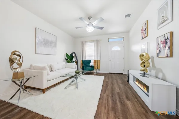 a living room with furniture and wooden floor