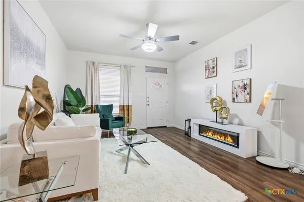a living room with furniture and a chandelier