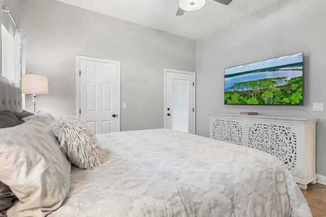 a bedroom with a bed and a painting on the wall