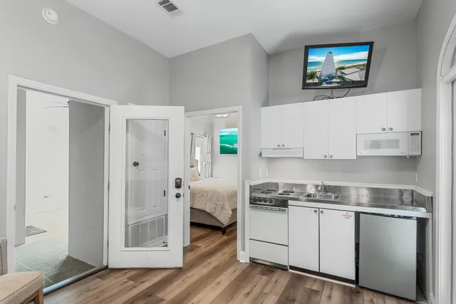 a kitchen with stainless steel appliances white cabinets and a refrigerator
