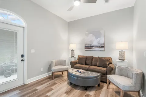 a living room with furniture and a wooden floor