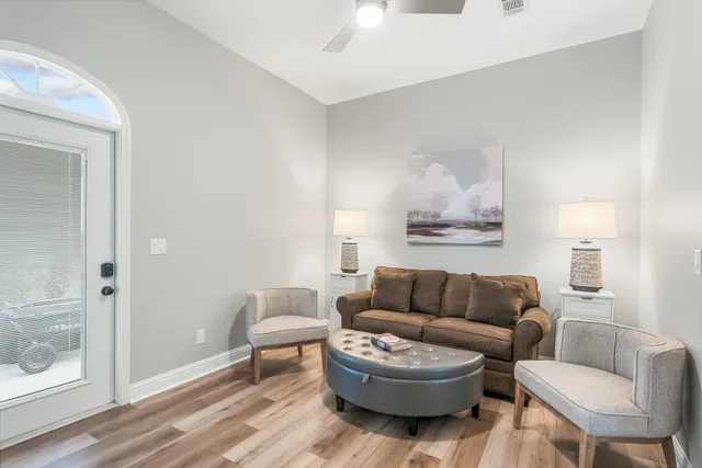 a living room with furniture and a wooden floor