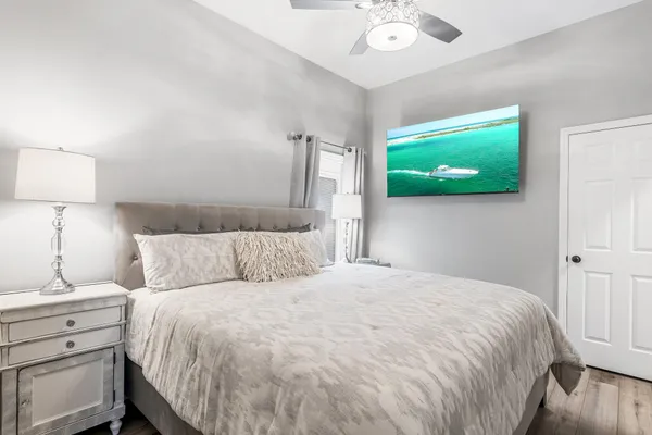 a bedroom with a bed and a flat screen tv