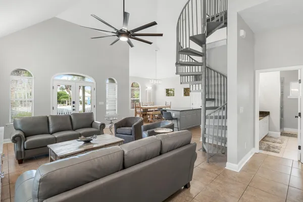 a living room with furniture and a chandelier