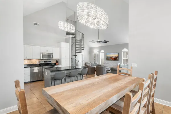 a large kitchen with a table and chairs