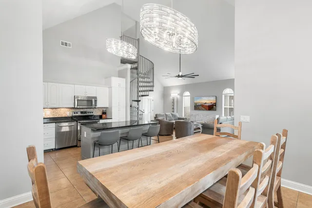 a large kitchen with a table and chairs