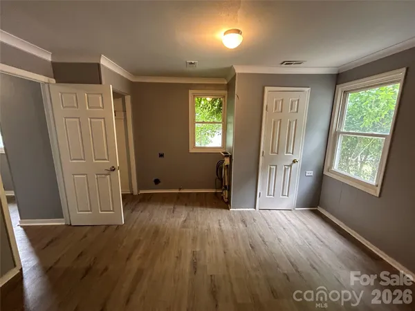 an entryway with wooden floor and window