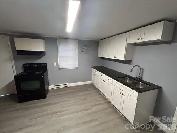 a living room with furniture and a air conditioner vent