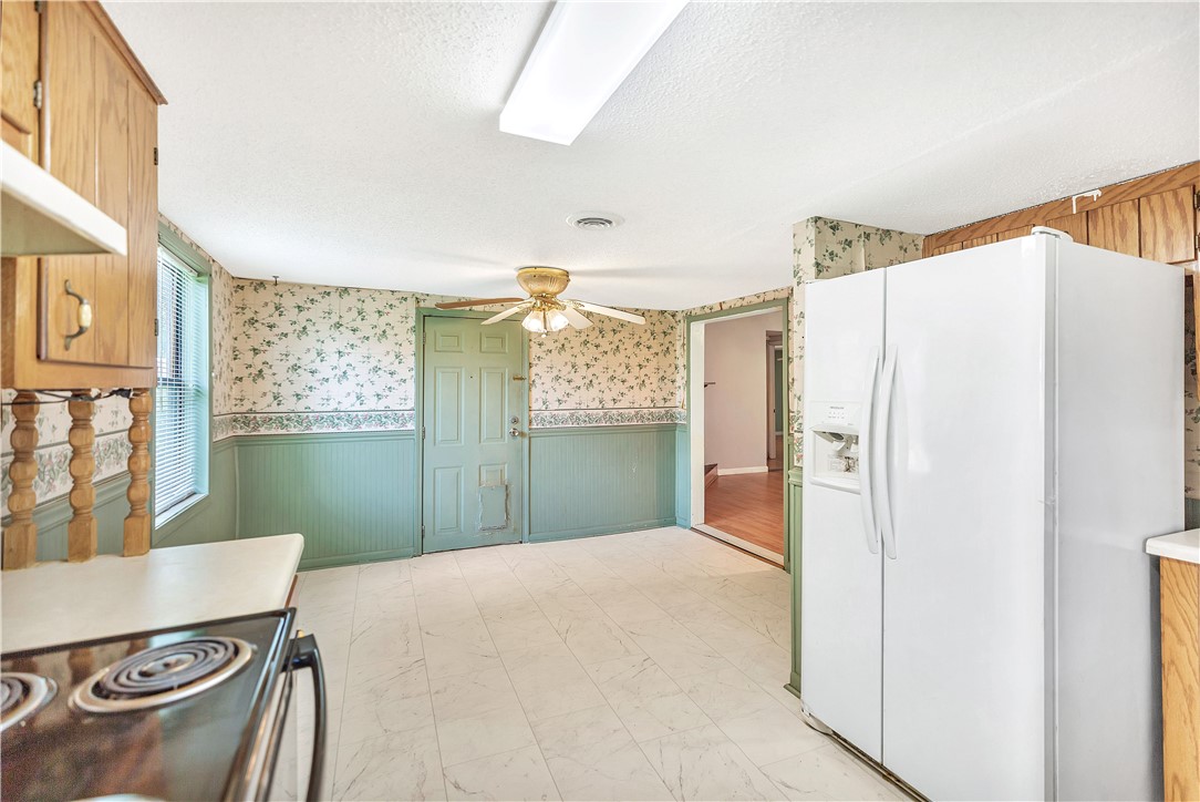 1004 Wiles Road Anderson, SC 29625 - Photo 13 of 26 A well-lit kitchen with patterned wallpaper and a functional range ready for culinary creations.