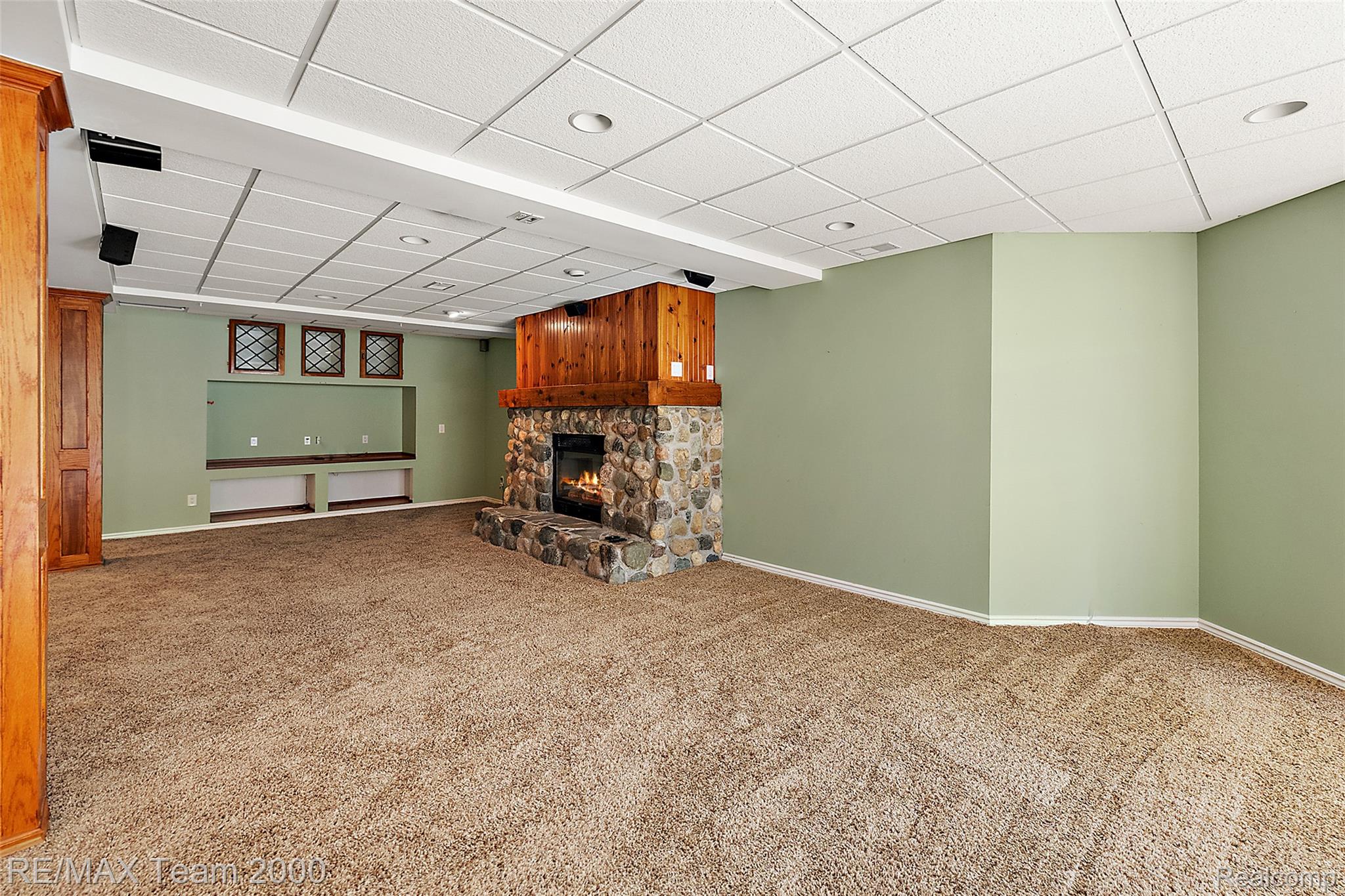 630 Sheldon Court Rochester, MI 48306 - Photo 69 of 94 Unfurnished living room featuring a paneled ceiling, a fireplace, and carpet floors