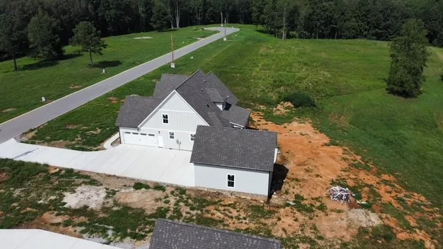 an aerial view of a house with a yard