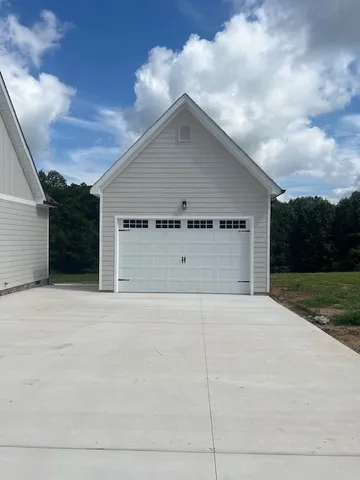 a view of a house with wooden floor next to a yard