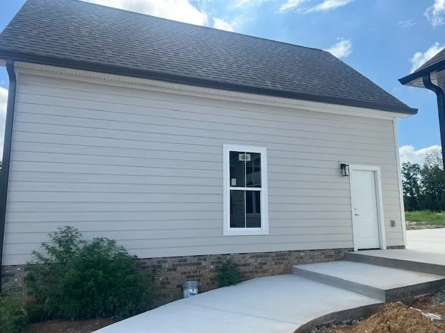 a kitchen with granite countertop a stove a sink and a window
