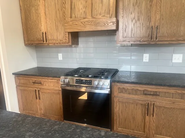 a kitchen with granite countertop wooden floors and a sink