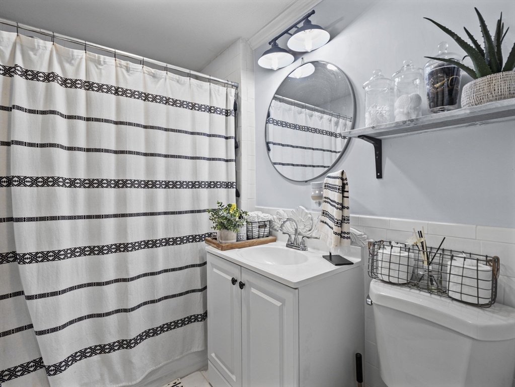 8 Clarks Court Lowell, MA 01852 - Photo 11 of 33 a bathroom with a sink and a mirror