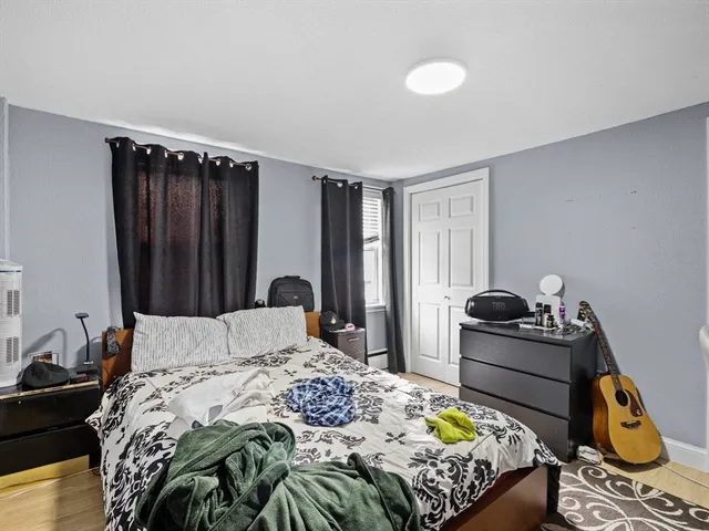 a bedroom with a bed and dresser