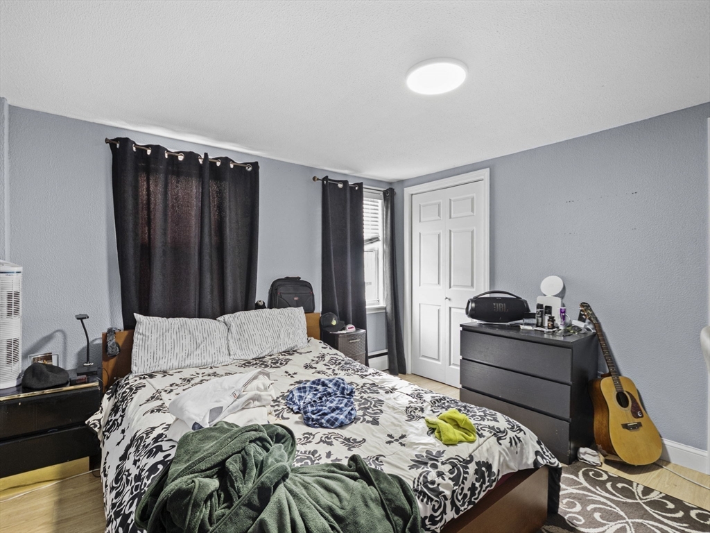 8 Clarks Court Lowell, MA 01852 - Photo 18 of 33 a bedroom with a bed and dresser