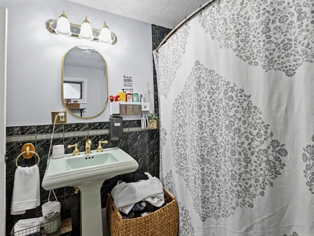 a bathroom with a sink a mirror and a toilet