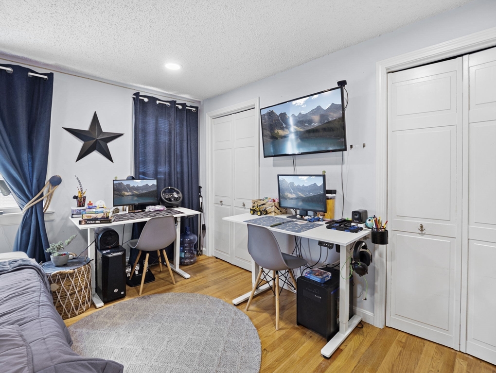 8 Clarks Court Lowell, MA 01852 - Photo 23 of 33 a workspace with furniture and a flat screen tv