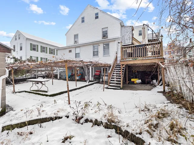 a view of a house with a yard covered in snow