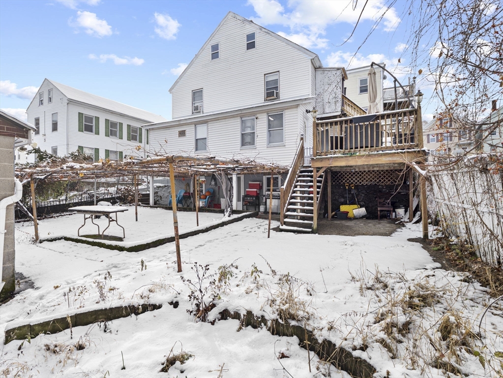 8 Clarks Court Lowell, MA 01852 - Photo 25 of 33 a view of a house with a yard covered in snow