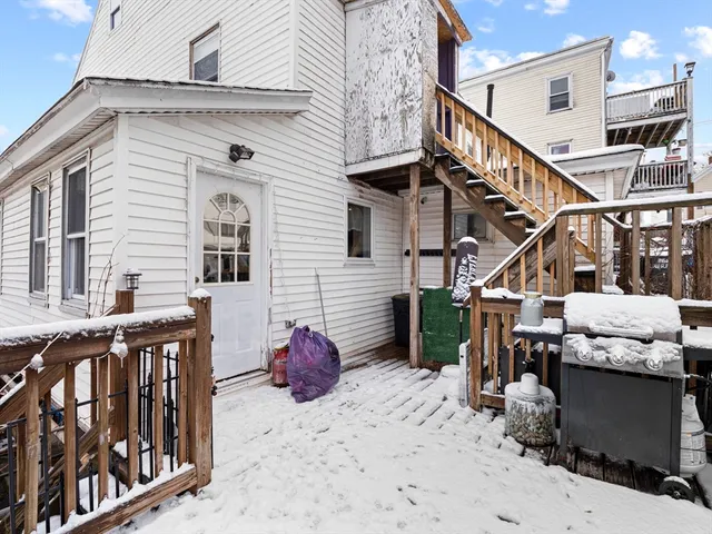 a view of a house with a wooden deck