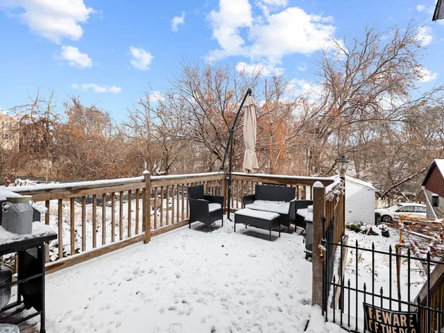 a view of a terrace with couches and wooden fence