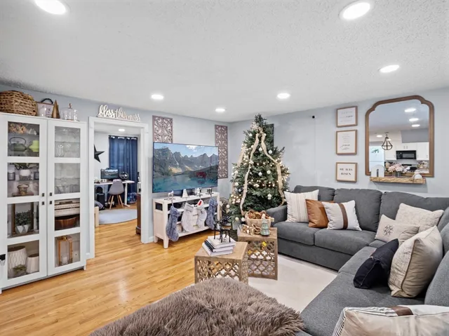 a living room with furniture and a wooden floor
