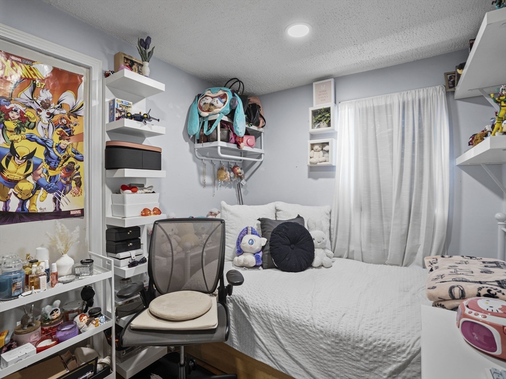 8 Clarks Court Lowell, MA 01852 - Photo 10 of 33 a bathroom with a sink a toilet and a shower curtain