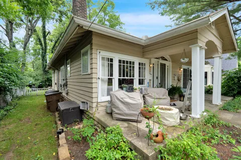 a view of a house with backyard and sitting area