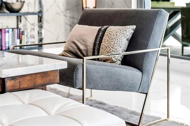 a living room with furniture and a floor to ceiling window