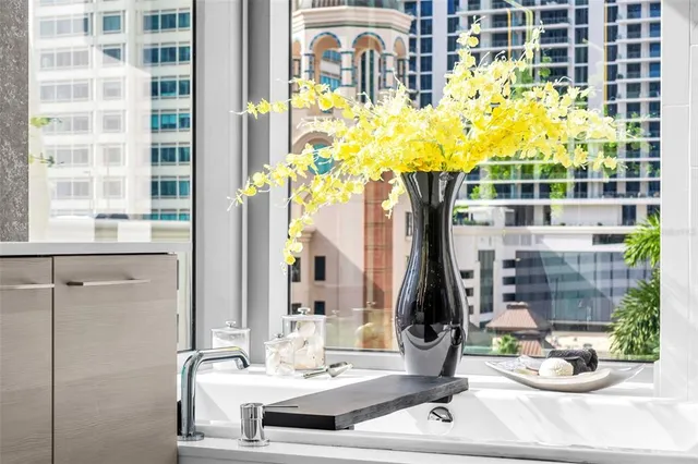 a living room with furniture a flat screen tv and kitchen view