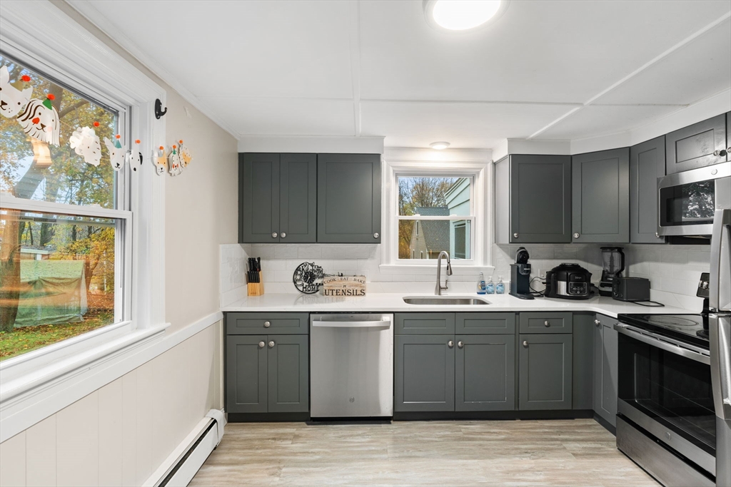 19 Cedar Street Beverly, MA 01915 - Photo 11 of 33 a kitchen with stainless steel appliances a sink stove and window